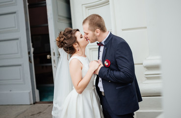 Stylish bride hugs and kiss beautiful bride, holding her hand, a romantic concept, close-up.