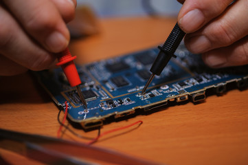 Electrician working with multimeter, closeup