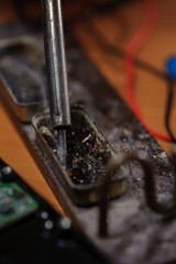 Closeup of soldering iron on table