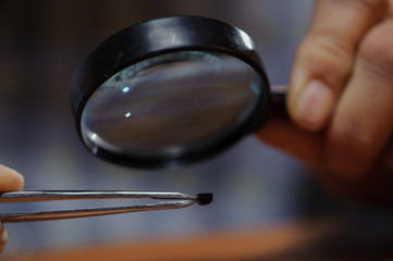 Electrical engineer checking diode with magnifier