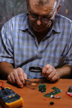 Senior electrician checking chips