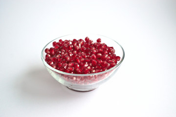 Pomegranate seeds in a clear bowl