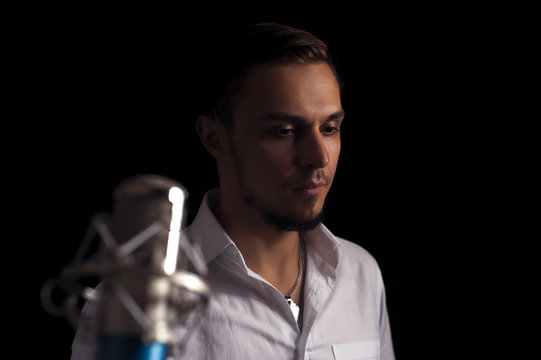 Portrait of young attractive singer with mic