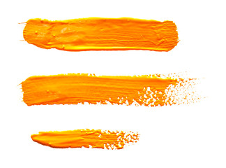  Three ochre yellow strokes of the paint brush isolated