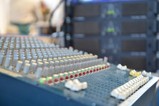 close-up of the control buttons on a music mixer