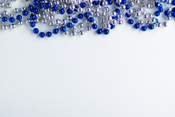 blue and metallic beads on a white background decoration Christmas and new year