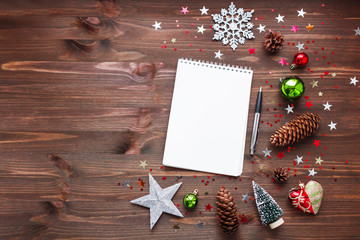 Christmas and New Year background with notepad, pen and decorations. To do list or list of promises, place for your text. Mock up.
