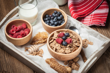 Bowl of cereals with blueberries and raspberrie.