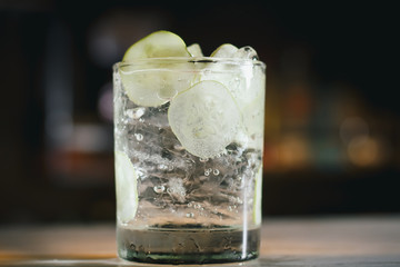 Gin tonic cocktail with cucumber and ice.