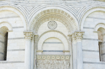 Classical wall with graceful columns and arches in Pisa, Italy