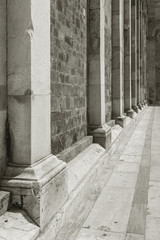 Columns against stone wall