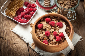Bowl of cereals with blueberries and raspberrie.