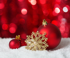 Naklejka na ściany i meble Christmas Baubles on red background with sparkles .