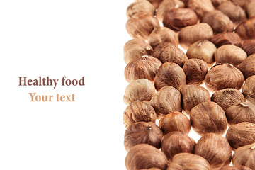 Hazelnut border on white background. Pile of selected hazel close-up. Isolated. For vegetarians.