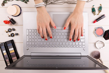 fashion blogger concept - woman with red polished nails working