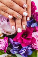 Beautiful manicure of gel varnish. Golden White. Fashion, style, care