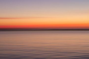 Naklejka na ściany i meble Blurred sunset, sky and sea