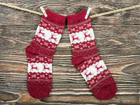 Christmas Socks Hanging On The Wooden Background