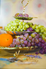 Fruits lie on a three-tiered fruit plate.