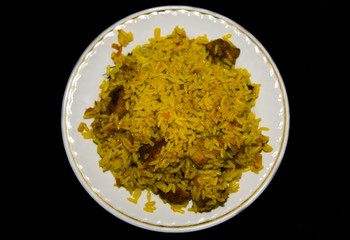 The dish is Uzbek pilaf on a dark background.