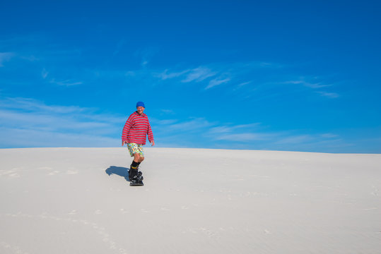 Sand boarding. Snowboarder preparing for a new winter.