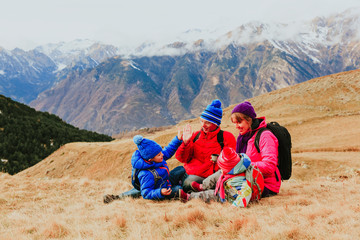 Fototapeta premium family with two kids travel in scenic winter mountains
