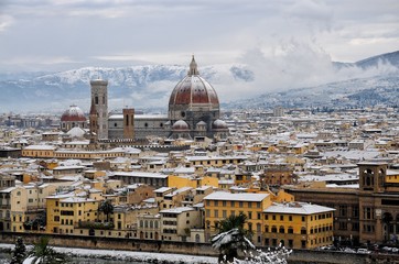 Fototapeta na wymiar Cathedral Santa Maria del Fiore (Duomo) and Giottos Bell Tower (Campanile), in winter with snow Florence, Tuscany, Italy