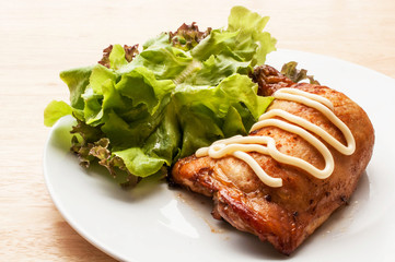 homemade grilled chicken and salad on wooden table