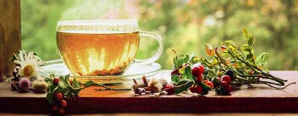 Photo sur Plexiglas Theé Tasse de thé sur le rebord de la fenêtre. Thé chaud. Feuilles de thé au fond de la tasse. Thé délicieux. Le thé attend... C& 39 est l& 39 heure du thé !