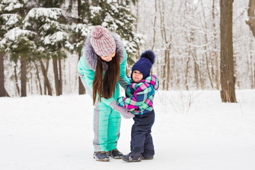 Mother and child enjoying beautiful winter day outdoors