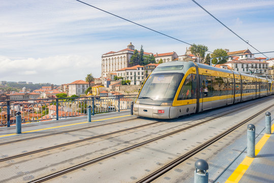 Porto Oporto metro subway tram train railway bridge Douro river rail public transport empty street sunny day - Powered by Adobe