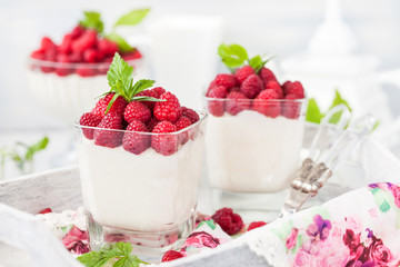 Delicious sweet  mousse decorated with fresh raspberries