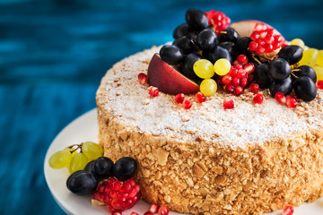 Delicious homemade honey cake decorated with fresh fruits