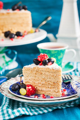 Piece of homemade  honey cake decorated with fresh fruits