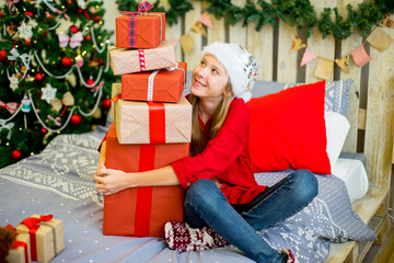 Obraz na płótnie Canvas happy child girl with Christmas gifts