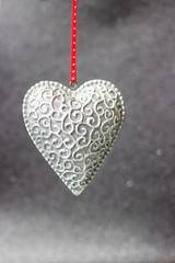 Beautiful silver heart on a shiny background