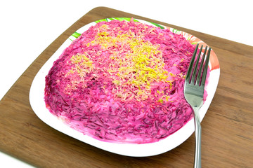 Russian cuisine: Salad herring under fur coat in a plate on a cu