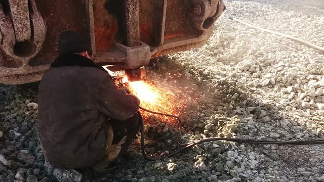 Russian worker cuts metal welding