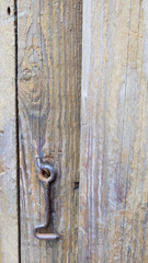 The lock a hook on an old door.