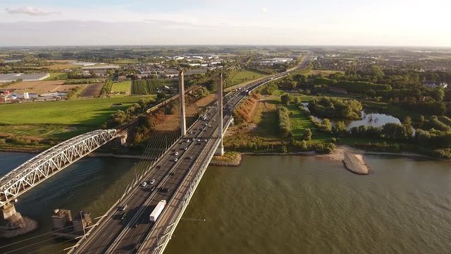 Aerial of bridge over river Waal in the Netherlands with traffic on long highway.