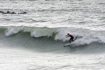 a surfer surf a wave in italy