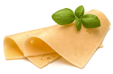 cheese slices and basil herb leaves isolated on white background