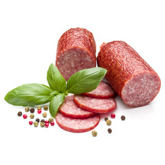 Salami smoked sausage, basil leaves and peppercorns isolated on