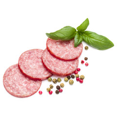 Salami smoked sausage slices, basil leaves and peppercorns isola