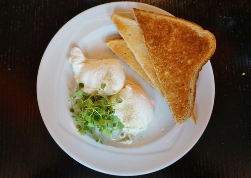 English breakfast of poached eggs and brown toast