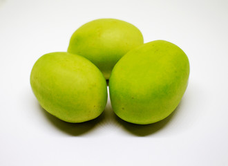 Green tomatoes on white background. Bunch of vegetables for salad or soup.