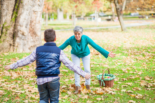 Boy running to grandmother in the park