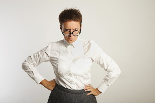 Angry Female Teacher In Round Black Glasses And Conservative Outfit Frowning Isolated On White