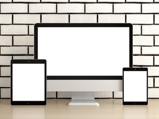Responsive devices on desk with isolated screen for mockup. Computer display, laptop, tablet and smart phone.