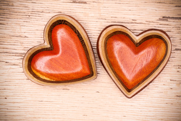 Fototapeta na wymiar Two wooden hearts on rustic wood background. Valentines days con